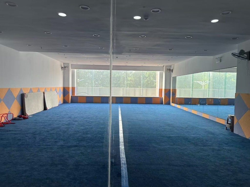 Indoor training hall with blue mats